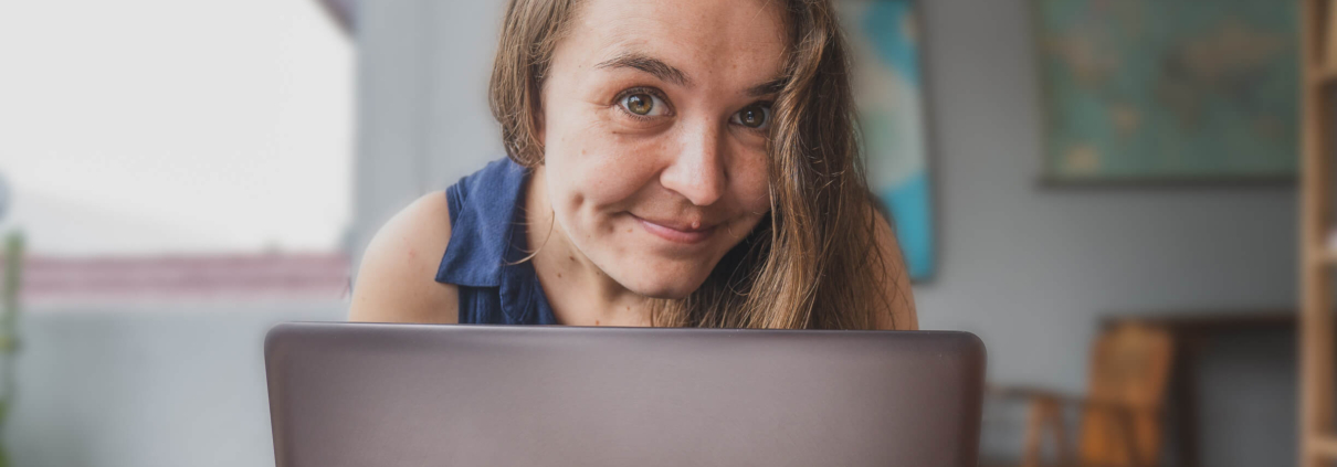 Amanda poking her head up from behind a laptop